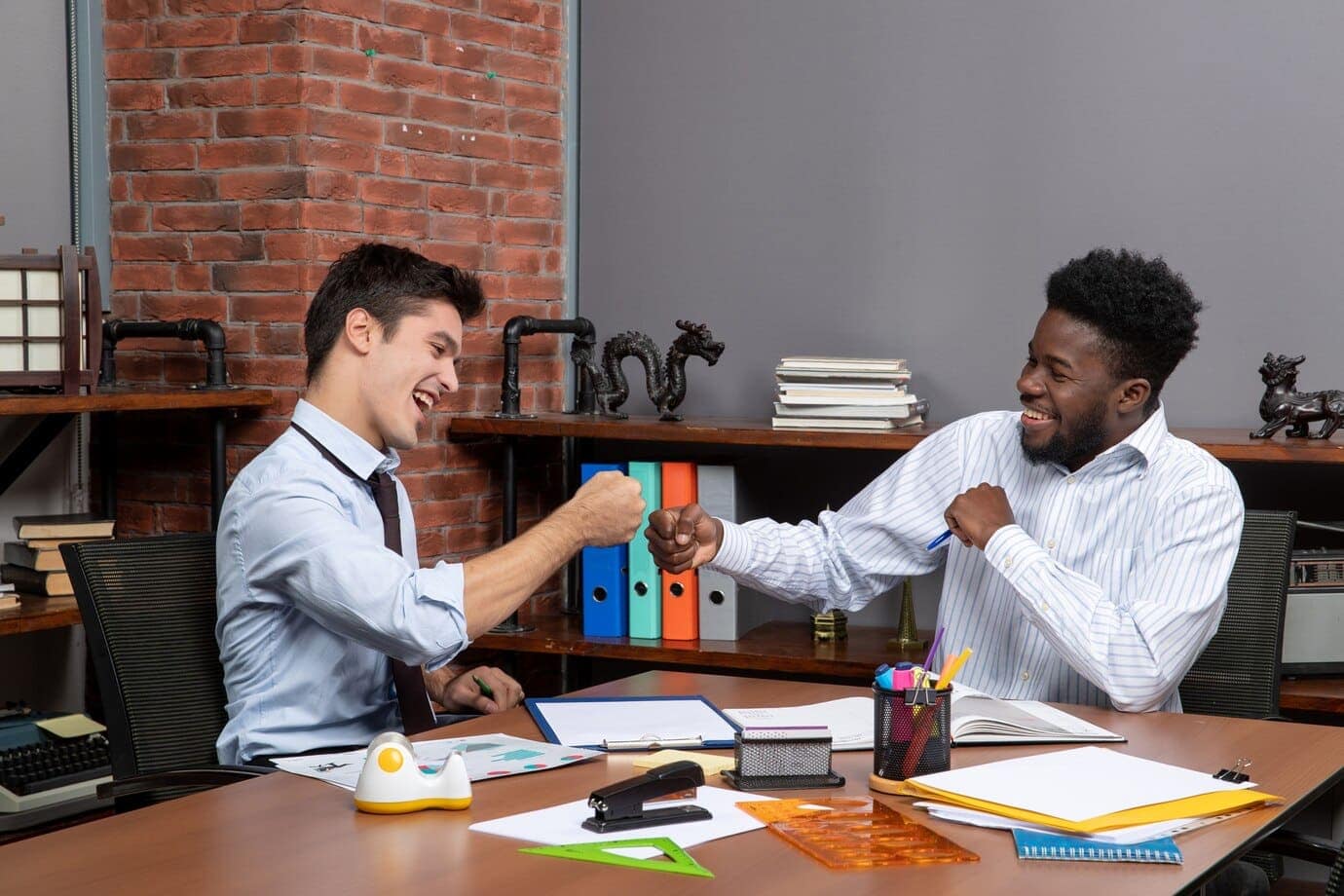 How to make a revokable trust in Texas. 7 front view two businessmen fist bump together 140725 109502 1