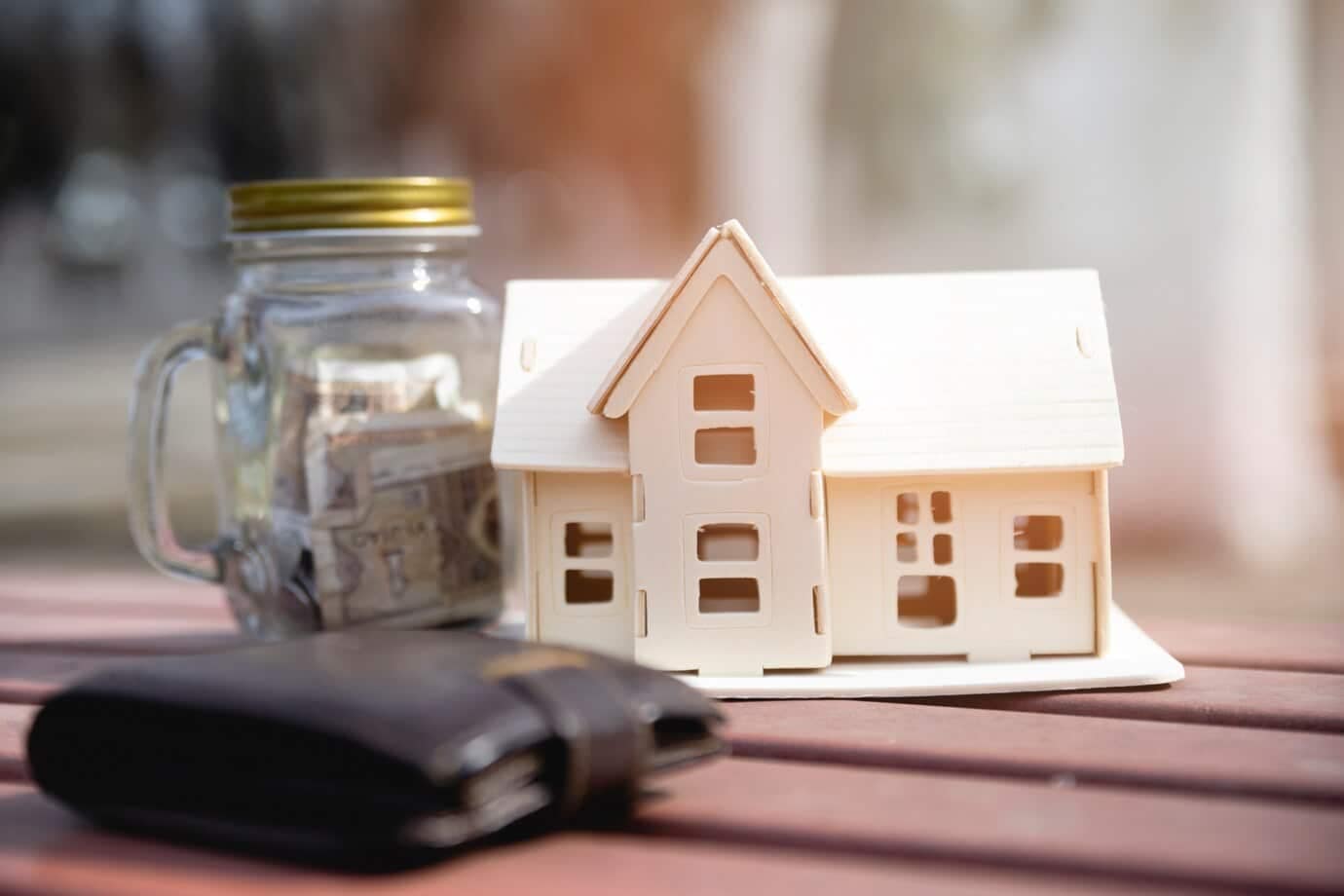 House Deed Definition: What You Need to Know 7 miniature house with savings jar wallet 23 2148081091