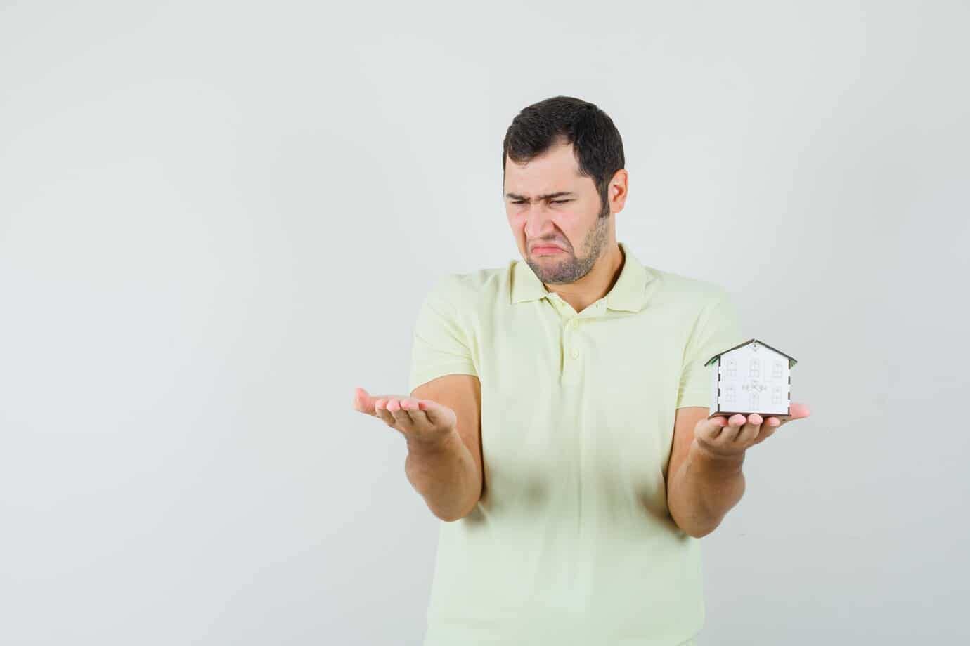 What property does not pass under a will in Wisconsin? 7 young man holding house model looking his palm t shirt looking disappointed 176474 48503