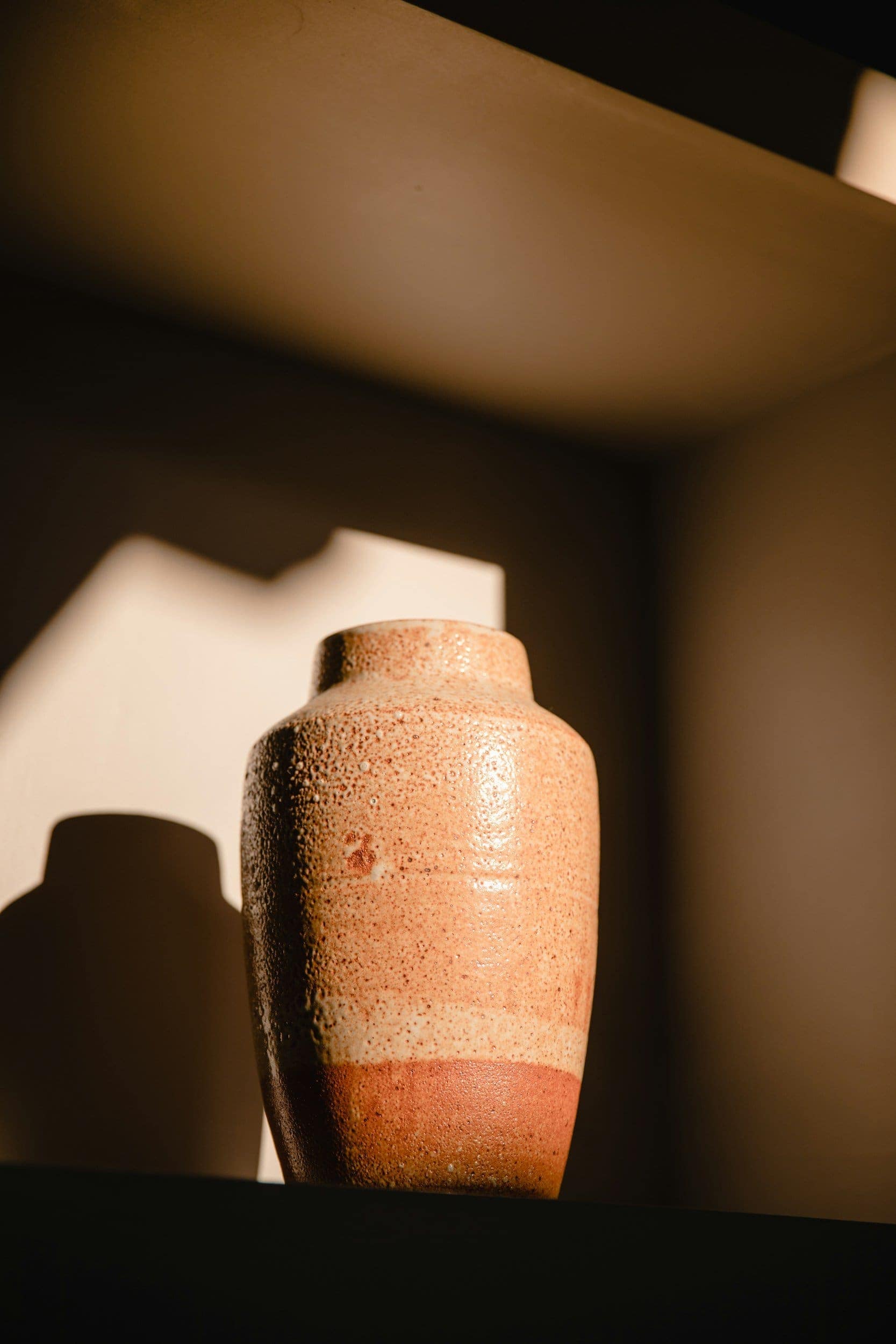 Questions to Ask When Ordering an Urn 3 A ceramic urn lit against a dark background