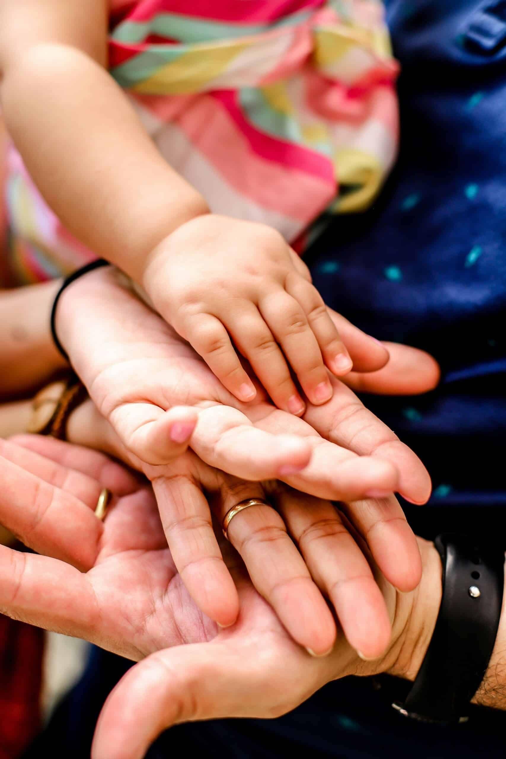 Beneficiary Designation vs Will - What You Need to Know 3 An adult's and a child's hands cupped together