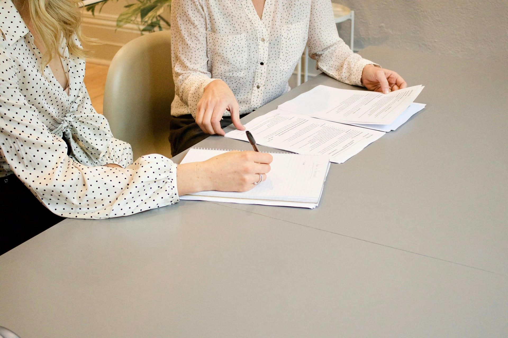 Do You Need to Avoid Probate? 3 Two people signing paperwork at a table