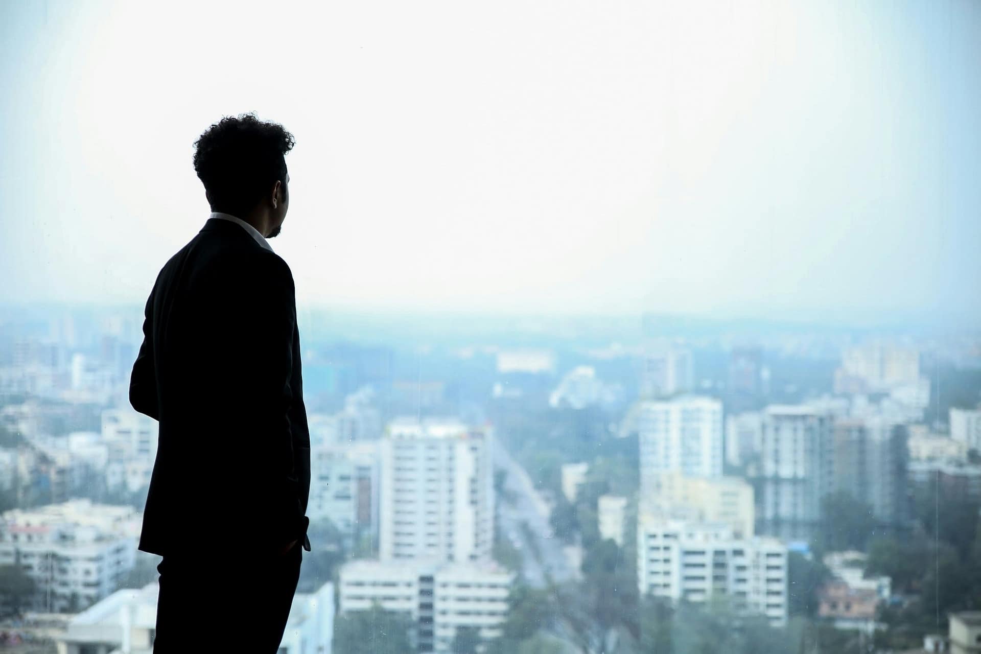 Can an Executor Override a Beneficiary? 3 A person in silhouette looking out over a city skyline
