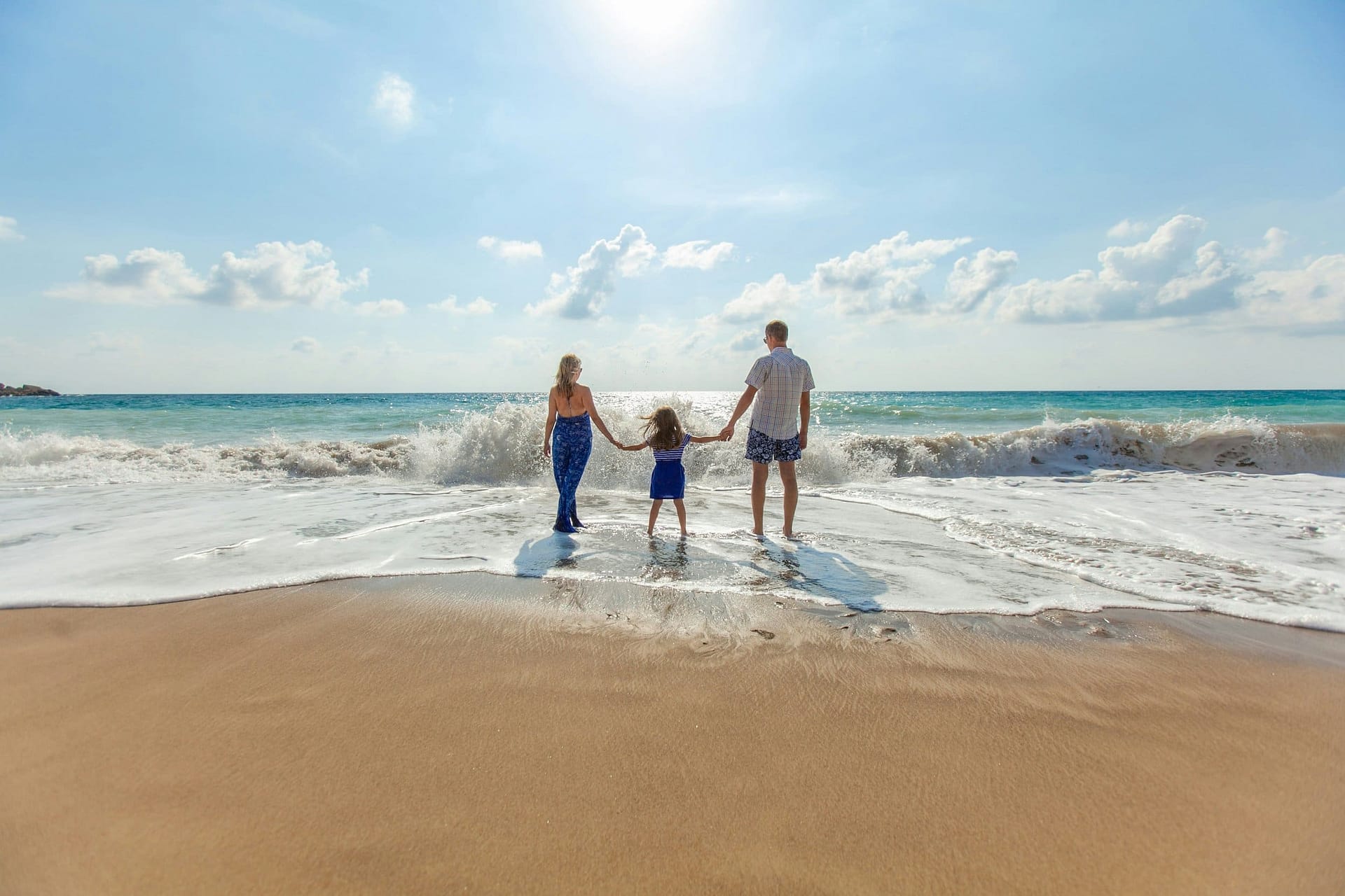 How to Claim Life Insurance After a Death 3 A family walking together on a beach at the water's edge