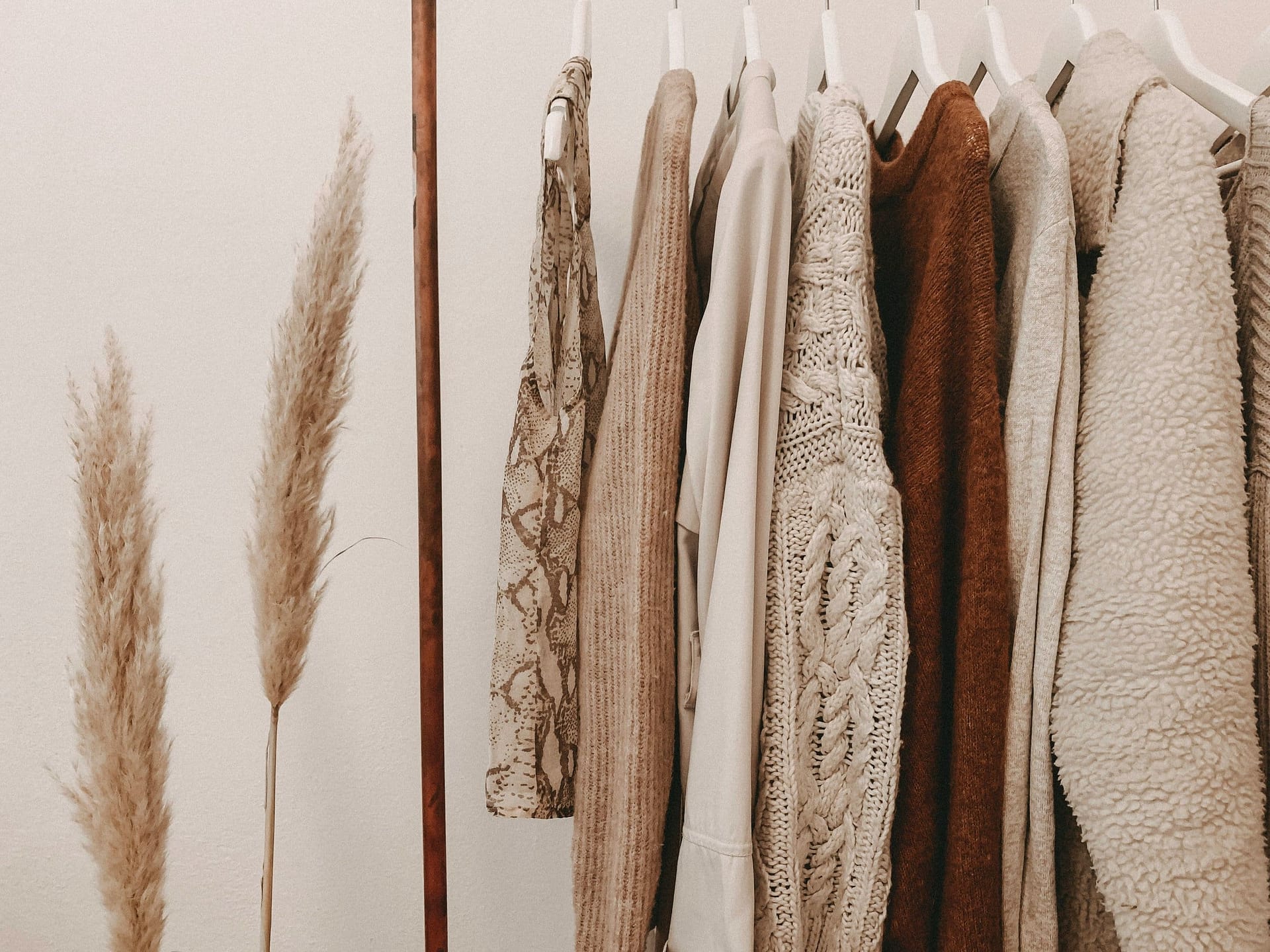 Estate Sale Companies: Finding The Perfect Fit 3 Clothes hanging on a rail beside dried grasses